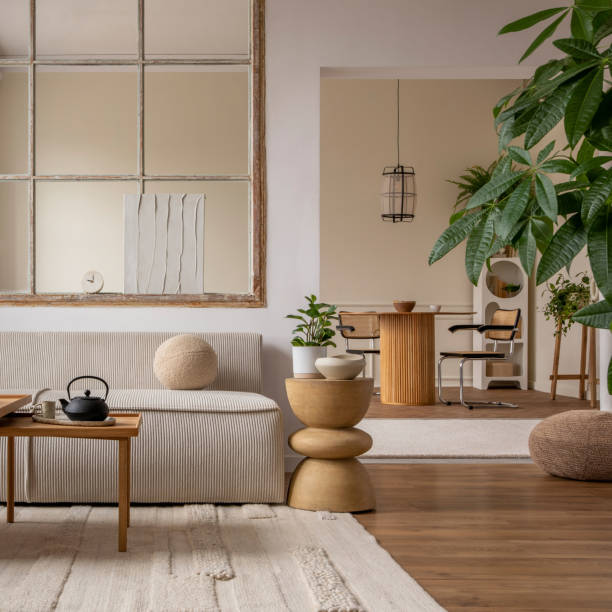 istock Open space interior with modular sofa, wooden coffee table, big window, beige rug, round pillow, stylish table, lamp, plants, vase with leaves and personal accessories. Home decor. Template. 1495354764
