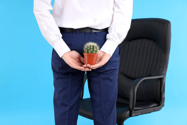 Man with cactus on blue background. Hemorrhoids concept