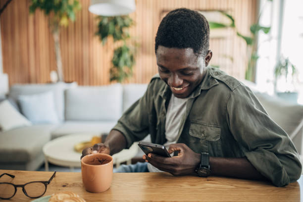 istock Young man relaxing at home and using mobile phone 1495359739