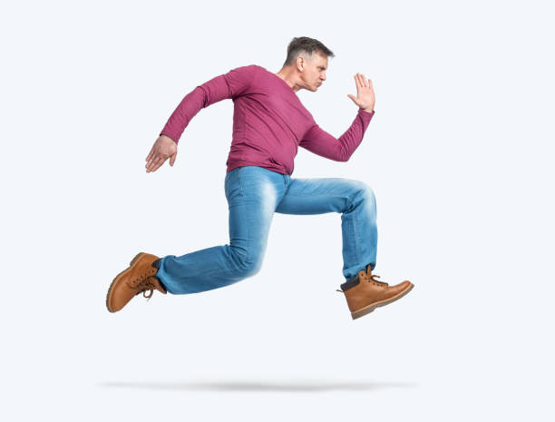 istock Man running in a hurry in casual clothes, side view, isolated on a light blue background 1495359931
