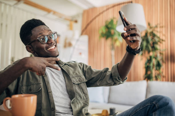istock Young man relaxing at home and using mobile phone 1495361030