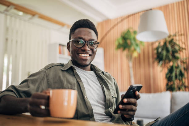 istock Young man relaxing at home and using mobile phone 1495361157