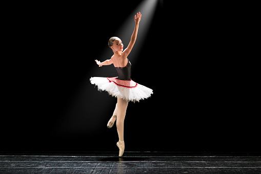 Young girl dancing Paquita Mazurka ballet variation on stage.