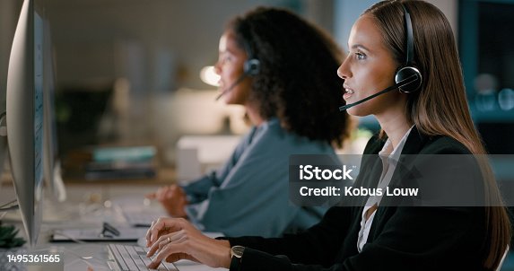 istock Call center, night and consulting with business people in office for customer service, telemarketing and help desk. Technical support, communication and contact us with female employee for networking 1495361565