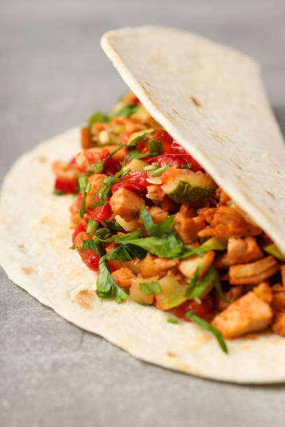 istock Tasty taco on grey textured background, close up 1495361863