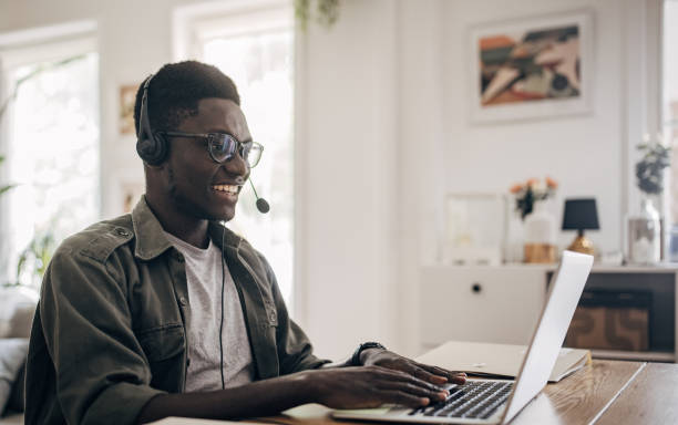 istock Young man working at home and having video call and e learning 1495362769