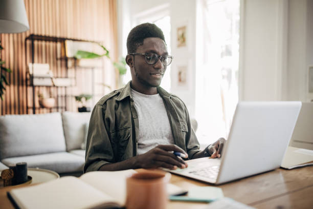 istock Man working on laptop at home 1495364523