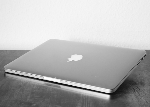 Illingen, Germany – June 01, 2023: A grayscale shot of a Macbook Pro on the table