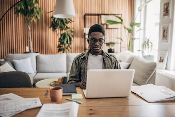 istock Man working on laptop at home 1495364829