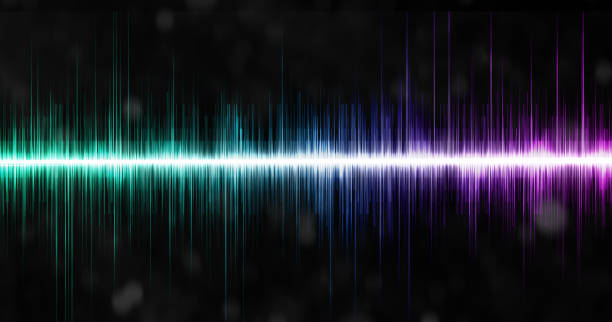 istock Sound waves oscillating with green, blue and purple glows of light. 1495366394
