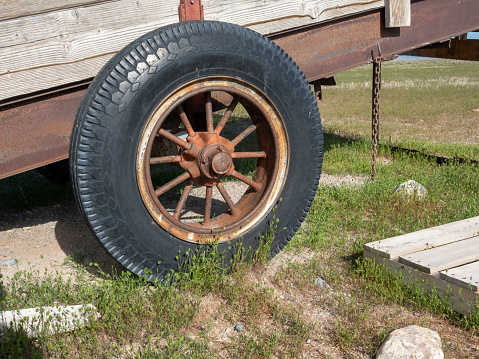 Old spoked wheel on a livestock loading ramp.