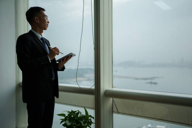 istock business man by the French window 1495368916
