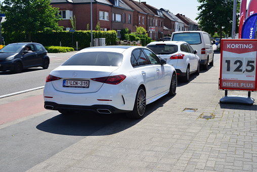 Leuven, Vlaams-Brabant, Belgium- June 2, 2023: stationary luxury white sports car on a gas station