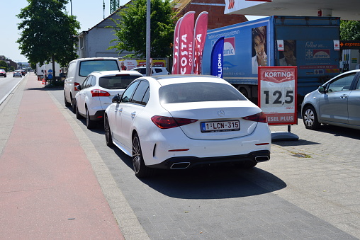 Leuven, Vlaams-Brabant, Belgium- June 2, 2023: stationary luxury white sports car on a gas station