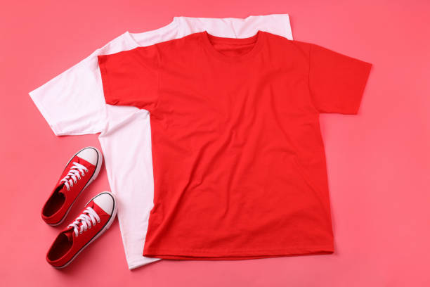 istock Blank t-shirts and sneakers on pink background 1495381528