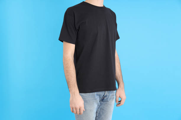 istock Man in blank black t-shirt on blue background 1495381753