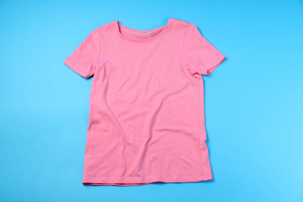 istock Blank pink t-shirt with space for print on blue background 1495382028