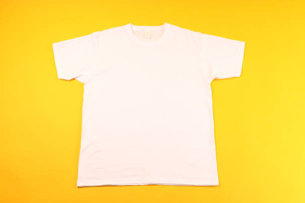 istock White t-shirt with space for print on yellow background 1495382691