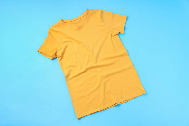 istock Blank yellow t-shirt with space for print on blue background 1495383568