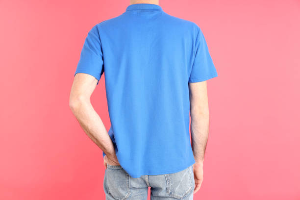 istock Man in blank blue polo on pink background 1495383860