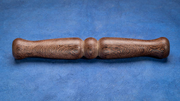 istock Wooden Tai Chi ruler, a  traditional Chinese exercise tool, rests on textured paper 1495384473