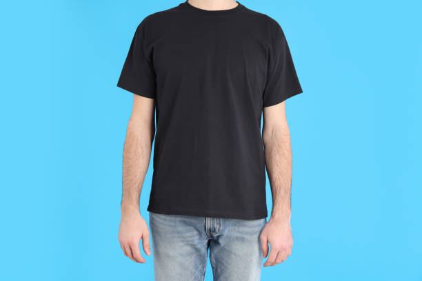 istock Man in blank black t-shirt on blue background 1495385125