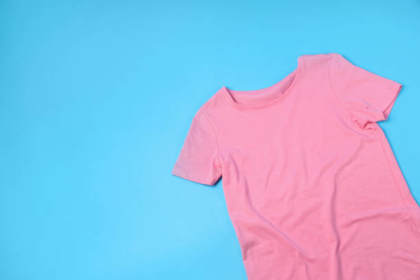 istock Blank pink t-shirt with space for print on blue background 1495385276