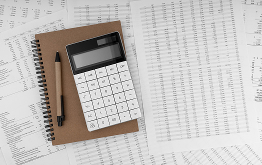 Calculator with notebook on financial documents. Financial concept.