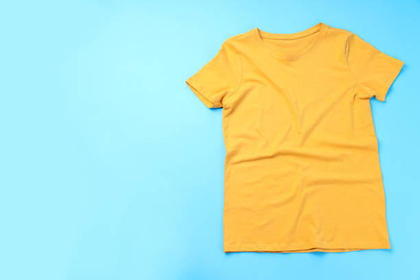 istock Blank yellow t-shirt with space for print on blue background 1495385725