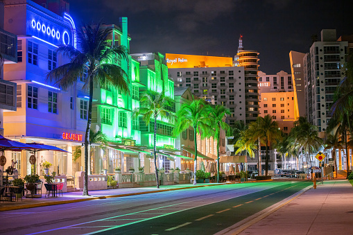 Colorful art deco buildings lit up along Ocean Drive, South Beach, Miami.
