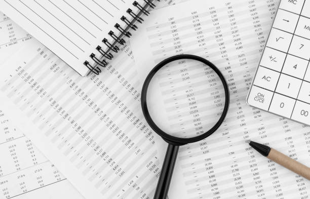 istock Calculator, magnifying glass, pen lying and notebook on financial statement. Financial concept. Top view. 1495385778