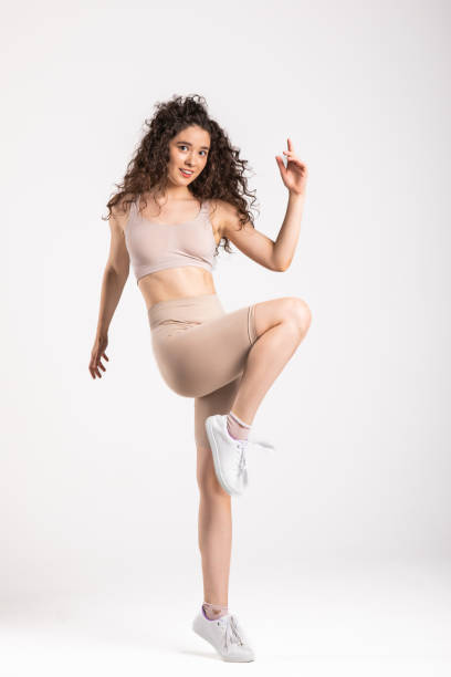 istock Athletic young woman exercising against white background 1495386754