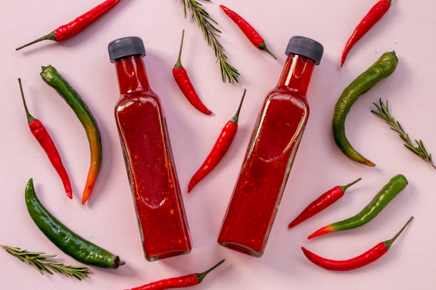 istock Red chili sauce ketchup or tabasco with ripe hot pepper 1495387155