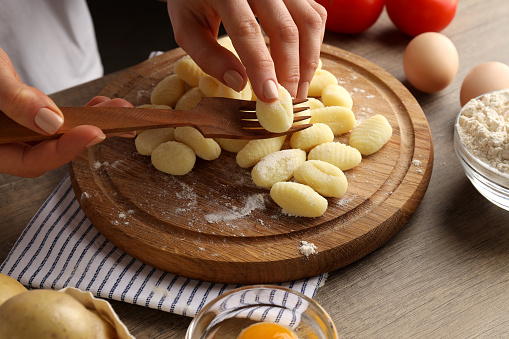 Concept of cooking with raw potato gnocchi, close up