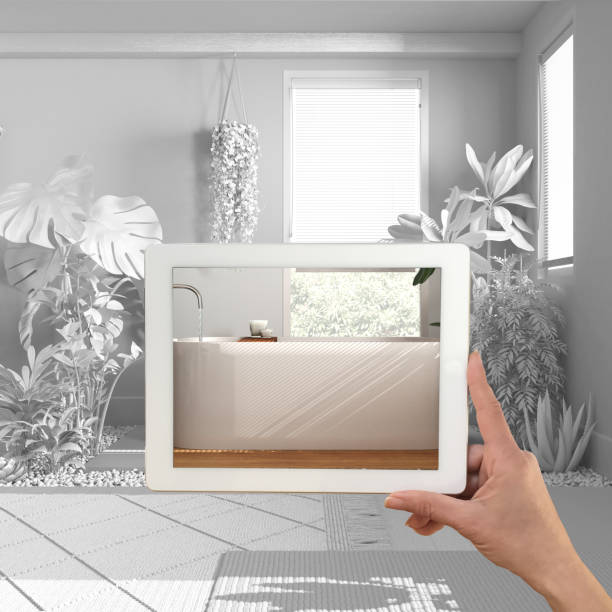istock Augmented reality concept. Hand holding tablet with AR application used to simulate furniture and design products in total white unfinished background, urban jungle bathroom 1495389196