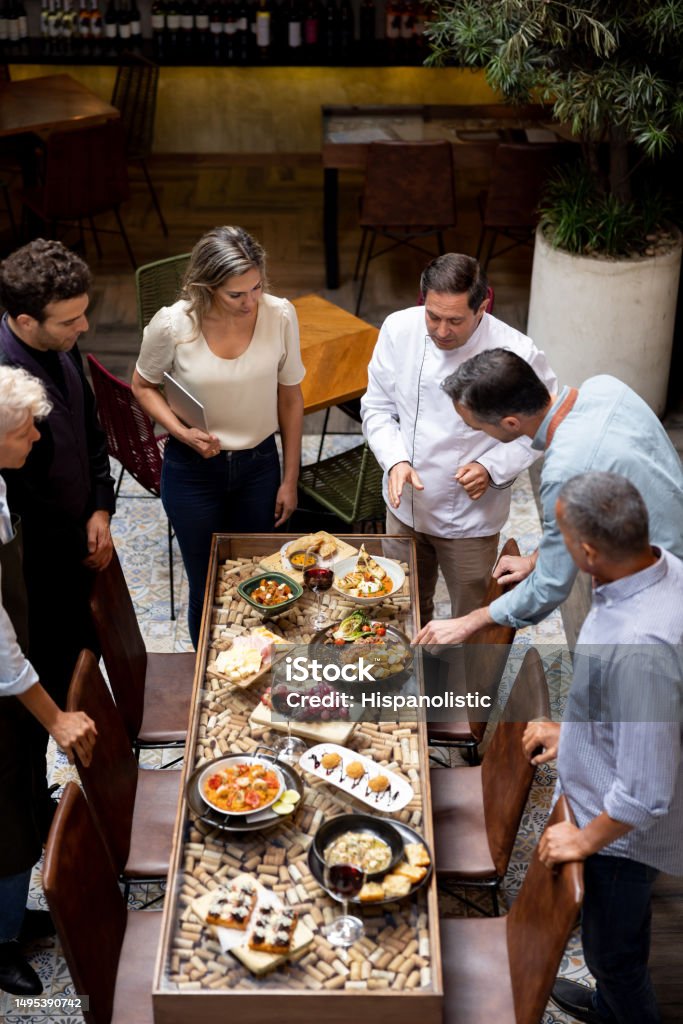 Chef And Menu Chef Presenting The Menu To His Staff At A Restaurant Stock Photo ...