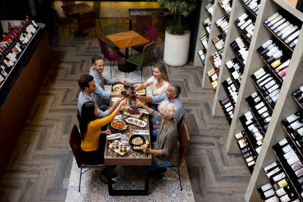 istock Happy friends eating at a restaurant and making a toast 1495390767