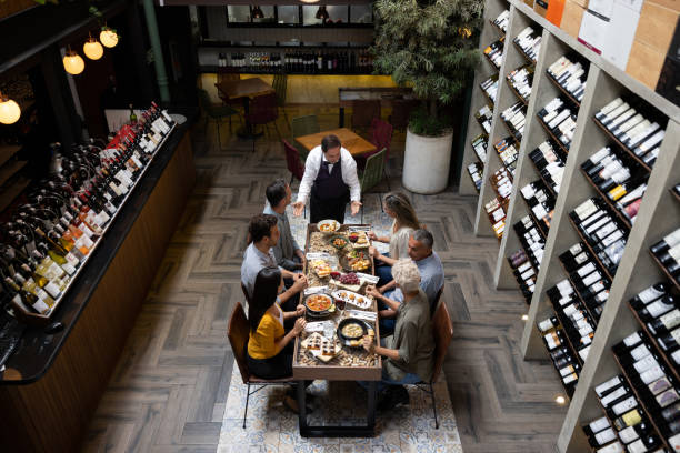 istock Waiter serving food to a group at a wine tasting experience 1495390771