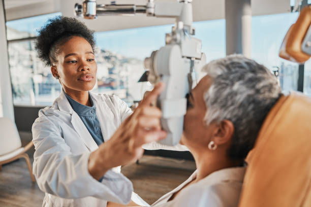 eye exam, vision and black woman with patient in optometry clinic for eyesight and optical assessment. healthcare, optometrist consultation and doctor medical equipment, phoropter and lens for eyes - human eye eyesight optometrist lens imagens e fotografias de stock