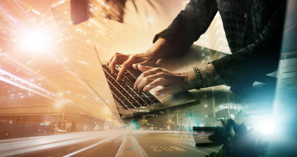 istock Laptop, planning and hands with city overlay or double exposure for civil engineering project management. Typing, software and information technology person or worker with urban development at night 1495393822