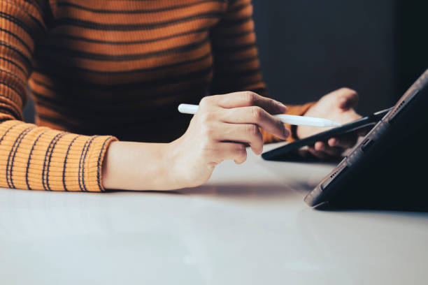istock Close up Woman Hands Holding Digital Pen. 1495394889