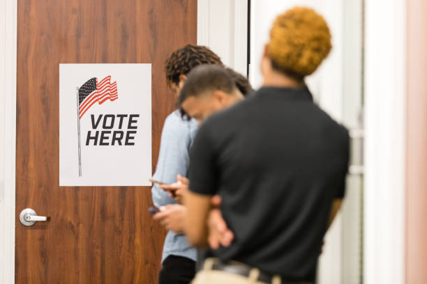 istock Diverse voters stand in line to enter polling place 1495396730