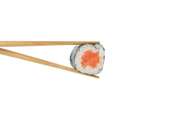 istock Chopsticks with maki isolated on white background 1495399058