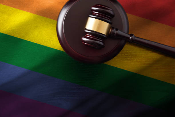 istock Judge mace on wooden base on LGBT flag 1495400390
