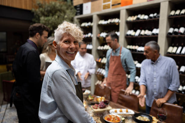 istock Happy waitress smiling in a staff meeting at a restaurant 1495400832