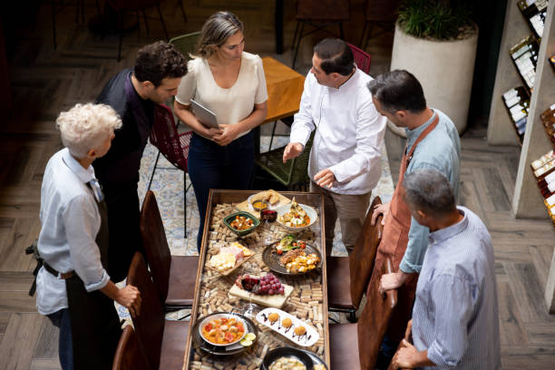 istock Chef presenting his new menu to his staff at a restaurant 1495400836