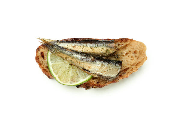 istock Delicious sandwich with sprats isolated on white background 1495401145