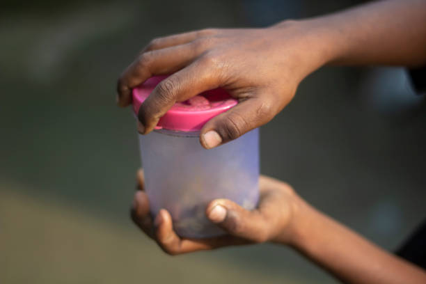 istock A man's hand is holding a plastic pot and the background is blurred 1495402657