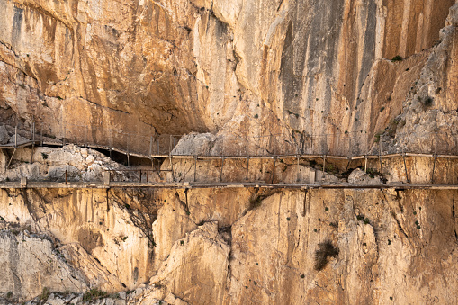Close-up of old and new walkway of the Caminito del Rey hike suspended on the side of the river canyon in Andalucia in Spain