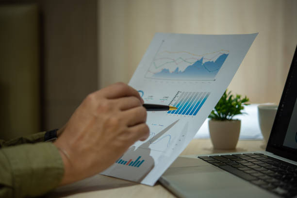 istock Business person working with financial documents analyzing. business investment information, financial and tax system planning and business strategies concept. 1495404054
